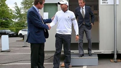 Sergio Garcia, centre, emerges from a meeting with George O'Grady, left, after which the latter was criticised for not taking any action on the golfer for his comments on fellow player Tiger Woods. Andrew Redington / Getty Images