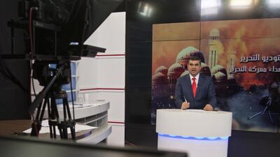 Bakr Mahmoud Mahdi, a presenter at the private Nineveh TV talking to callers on his live studio show, in Erbil, Iraq, which offers those outside glimpses of what is happening in ISIL-held Mosul, and also brings hope and encouragement to those still trapped in Iraq's second largest city. Fay Abuelgasim/AP Photo