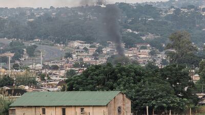 A police helicopter hovering over Bhambayi township as smoke rises in Durban. AFP