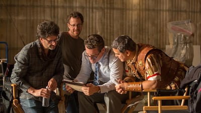From left, filmmakers Joel and Ethan Coen are joined by Josh Brolin as Eddie Mannix and George Clooney as Baird Whitlock on the set of Hail, Caesar!. Alison Rosa / Universal Pictures