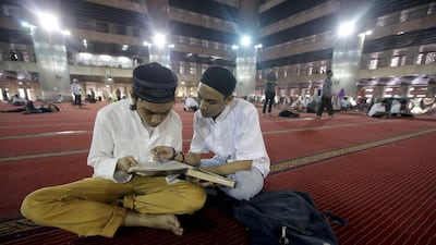Indonesian Muslims read the Quran after praying to celebrate the holy month of Ramadan at Istiqlal Mosque in Jakarta, Indonesia. EPA
