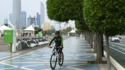 A man rides a bike along the Corniche in Abu Dhabi. Khushnum Bhandari for The National