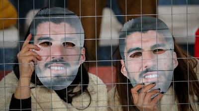 Fans of the Uruguayan side Nacional wearing Luis Suarez masks at Estadio Gran Parque Central, in Montevideo, on July 21, 2022. Masks and posters were given to fans to encourage the striker to return to the club where he made his professional debut in May 2005. EPA