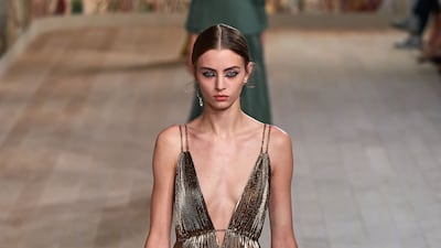 A molten origami gold dress, at Dior, autumn 2021 haute couture