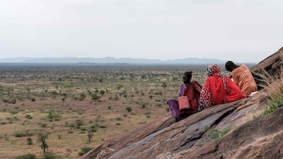Girls collect water from a hill after heavy rain near the Rabang displacement camp.