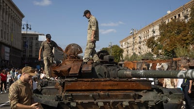 Ukrainian troops in Kyiv inspect the wreck of a Russian tank at an exhibition dedicated to Independence Day. Reuters