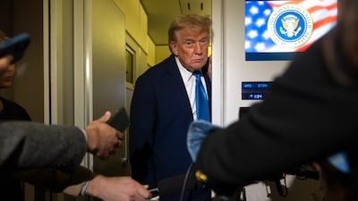 US President Donald Trump speaks with reporters on board Air Force One on his way from Calgary, Canada to Joint Base Andrews, Maryland. AP