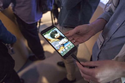 People examine a Google Pixel smartphone. Getty