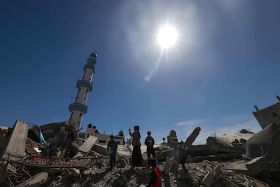 Palestinians amid the ruins of Al Farouq Mosque in Rafah, southern Gaza. AFP