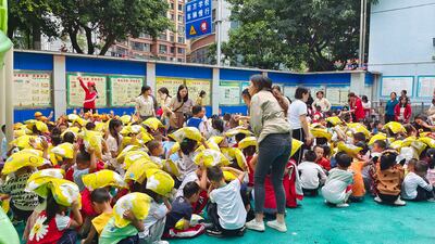 Children sit at playground in the city of Yaan, after being moved outside as a precaution. Xinhua News Agency/AP