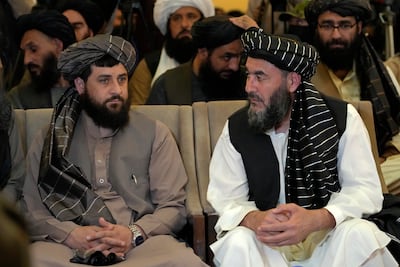 Bashir Noorzai, right, talks to acting Minister of Defence Mullah Mohammad Yaqoob during a release ceremony in Kabul on Monday. AP