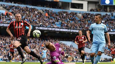 Manchester City's Sergio Aguero scores one of his three goals on Sunday against Queens Park Rangers in a 6-0 win at the Etihad Stadium. Nigel Roddis / EPA