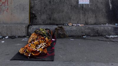 An anti-government protester rests by cement blocks separating protesters from riot police in Baghdad, Iraq. AP