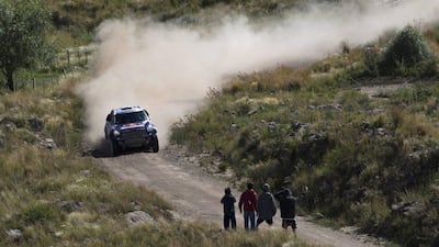 Mini driver Nasser Al-Attiyah of Qatar and co-pilot Matthieu Baumel of France, race towards victory in the opening leg of the 2015 Dakar Rally. Felipe Dana / AP Photo