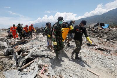 A victim of last week's earthquake is recovered in the Balaroa neighbourhood in Palu, Central Sulawesi, Indonesia. Reuters