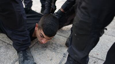 Israel police arrest a Palestinian youth outside the Damascus Gate in Jerusalem in October 2021. AFP