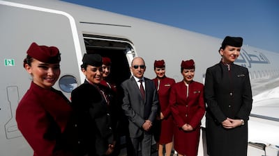 Qatar Airways chief executive Akbar Al Baker poses with cabin crew earlier this year. This week he claimed a woman would not be able to do his job. Murad Sezer / Reuters