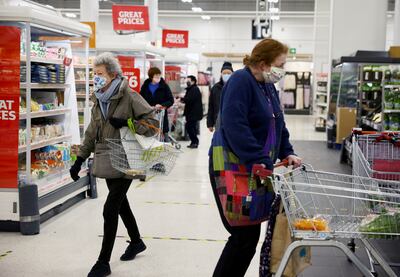 People shop at a Sainsbury's supermarket. The grocer's chief executive Simon Roberts says there is a lot of interest in the sector at the moment. Reuters