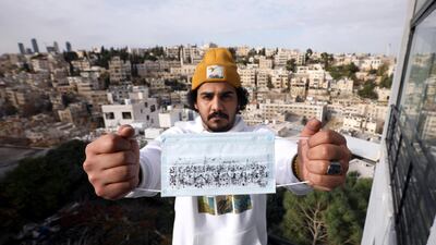 Jordanian artist and architect Saleh Mansour poses with his cityscape sketch on a mask to encourage people to wear them in Amman, Jordan. Reuters