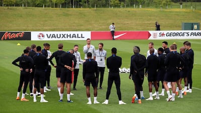 England assistant coach Steve Holland speaks to the players while manager Gareth Southgate listens during a training session at St Georges Park on May 28, 2018 in Burton-upon-Trent, England. Nick Potts / AP Photo
