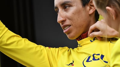 Colombia's Egan Bernal waves as he celebrates his overall leader's yellow jersey on the podium of Stage 19. Jeff Pachoud / AFP