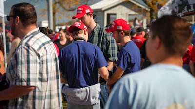 Donald Trump supporters wear Make America Great Again caps on November 2, 2024 (Joshua Longmore / The National)