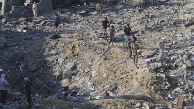 Palestinians carry belongings from a house which police said was destroyed in an Israeli air strike in Khan Younis in the southern Gaza Strip on Tuesday. Israel launched an offensive against Islamist Hamas in the Gaza Strip on Tuesday, bombing some 50 targets, including homes, in a campaign meant to end Palestinian rocket fire into the Jewish state. Ibraheem Abu Mustafa / Reuters
