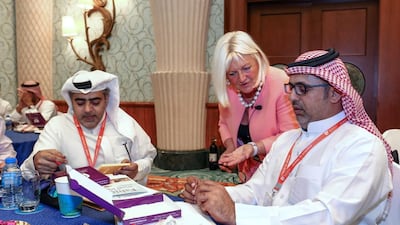 From left, Anwar Al Khalifa, Dr Bogusia Matusiak-Varley and Abdul Ghani Salman carry out the magnetic box exercise at the Journey to Excellence conference at the Atlantis. Victor Besa for The National