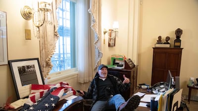 Richard Barnett, a supporter of US President Donald Trump, sits inside the US Capitol in Washington on January 6, 2021. AFP