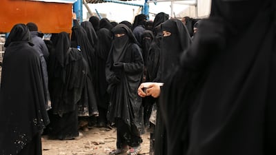 Women line up for aid supplies at Al Hol camp in Hasakeh province, Syria. AP