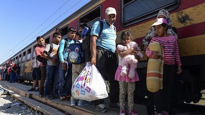 Refugees board a train heading to the border with Serbia, near the Macedonian town of Gevgelija, on September 13, 2015. Georgi Licovski/EPA