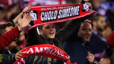 Athletico Madrid supporters hold up a Diego Simeone scarf in celebration during the Uefa Champions League quarter-final, second leg match between Atletico Madrid and FC Barcelona at the Vincente Calderon on April 13, 2016 in Madrid, Spain. (Photo by Mike Hewitt/Getty Images)