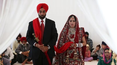 Devinder Singh and Manpreet Kaur from Punjab, India, during their marriage ceremony at the temple. The temple attracts Sikh couples from around the world who want a destination wedding.