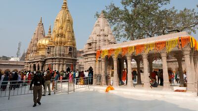 Policemen stand guard as Hindu devotees arrive to pray at Kashi Vishwanath Temple. (Reuters)