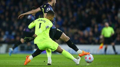 Spurs attacker Harry Kane tackles Brighton goalkeeeper Robert Sanchez before missing an early chance. Getty