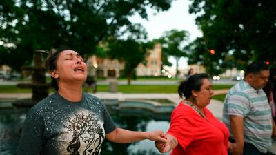 People pray during a vigil for the victims of a mass shooting at Robb Elementary School in Uvalde, Texas. AP
