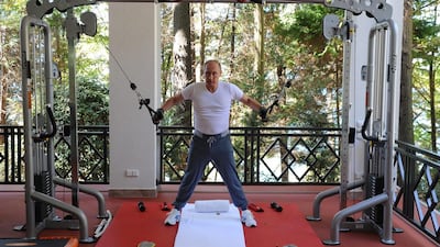 Russian President Vladimir Putin exercises during his meeting with Prime Minister Dmitry Medvedev, at the Black Sea resort of Sochi, Russia. RIA Novosti / AP Photo