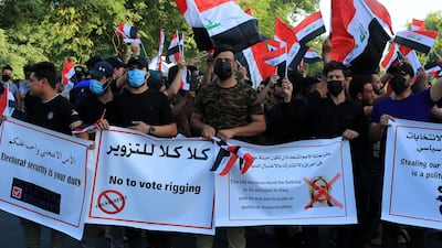 Supporters of Iran-backed Iraqi Shiite armed movements carry banners as they take part in a protest near the gate of the governmental Green Zone in central Baghdad. EPA