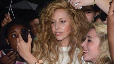 Lady Gaga poses for a picture with her fans as she leaves her Midtown Manhattan apartment. Getty Images