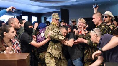 “Maidan” self-defence activists and activists of Ukrainian ultranationalist Right Sector party storm a Kiev City Prosecutors’ office in Kiev. The protesters stormed the building demanding the city prosecutors’ resignation and a purge of prosecutors who took part in the repressions of the anti-government protests on Kiev’s Independence Square. Sergei Supinsky / AFP