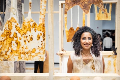 Maha Alasker with her installation Was the Maternal Cord to my Land Cut Before I was Born?. Photo: NYUAD
