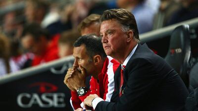 Manager Louis van Gaal of Manchester United looks dejected with assistant Ryan Giggs during their League Cup loss to MK Dons on Tuesday. Clive Mason / Getty Images / August 26, 2014