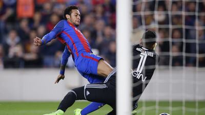 Barcelona’s Neymar, left, is challenged by Valencia’s goalkeeper Diego Alves. Manu Fernandez / AP Photo