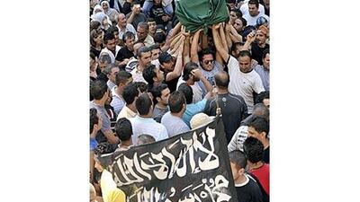 Zeina Miri's relatives and friends carry her coffin covered with the Islamic flag during her funeral.