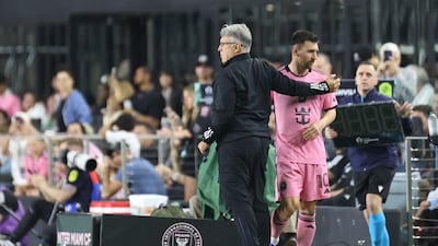 Inter Miami coach Gerardo Martino consoles Lionel Messi after his substitution on 50 minutes with what appeared a hamstring injury. AFP