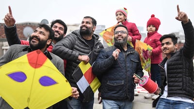 People fly kites on the occasion of Lohri festival in Amritsar. AFP