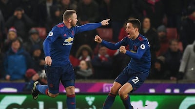 Wayne Rooney, left, celebrates his equalising goal against Stoke City. His injury-time free-kick ensured he became Manchester United's all-time leading goal-scorer. Getty