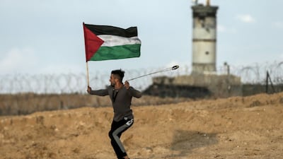 A Palestinian protester carries hurls stones during a demonstration in Beit Lahia near the maritime border with Israel, on November 5, 2018.AFP