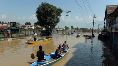 Kashmiri boatmen row their shikaras on the flooded Dal Lake as they assist in the evacuations in Srinagar, India. A small army of boatmen, who normally ferry holidaymakers around the lake, have spent the past week rescuing those stranded on sinking houseboats and bringing them to safety. Punit Paranjpe / AFP