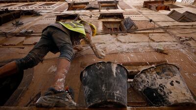 A man works on the restoration of a Unesco-listed building in the old city of Sanaa, Yemen. Dozens of workers, architects and senior master builders are engaged in urban renovation works since early June 2022 in the old quarter of the Yemeni capital, using traditional methods and materials to maintain its architectural style. EPA